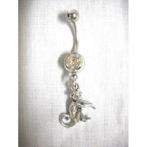 May include: Silver belly button ring with a clear crystal and a monkey charm.