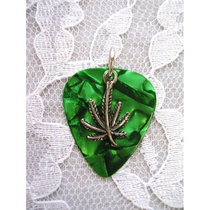 May include: Green guitar pick pendant with a silver marijuana leaf charm.