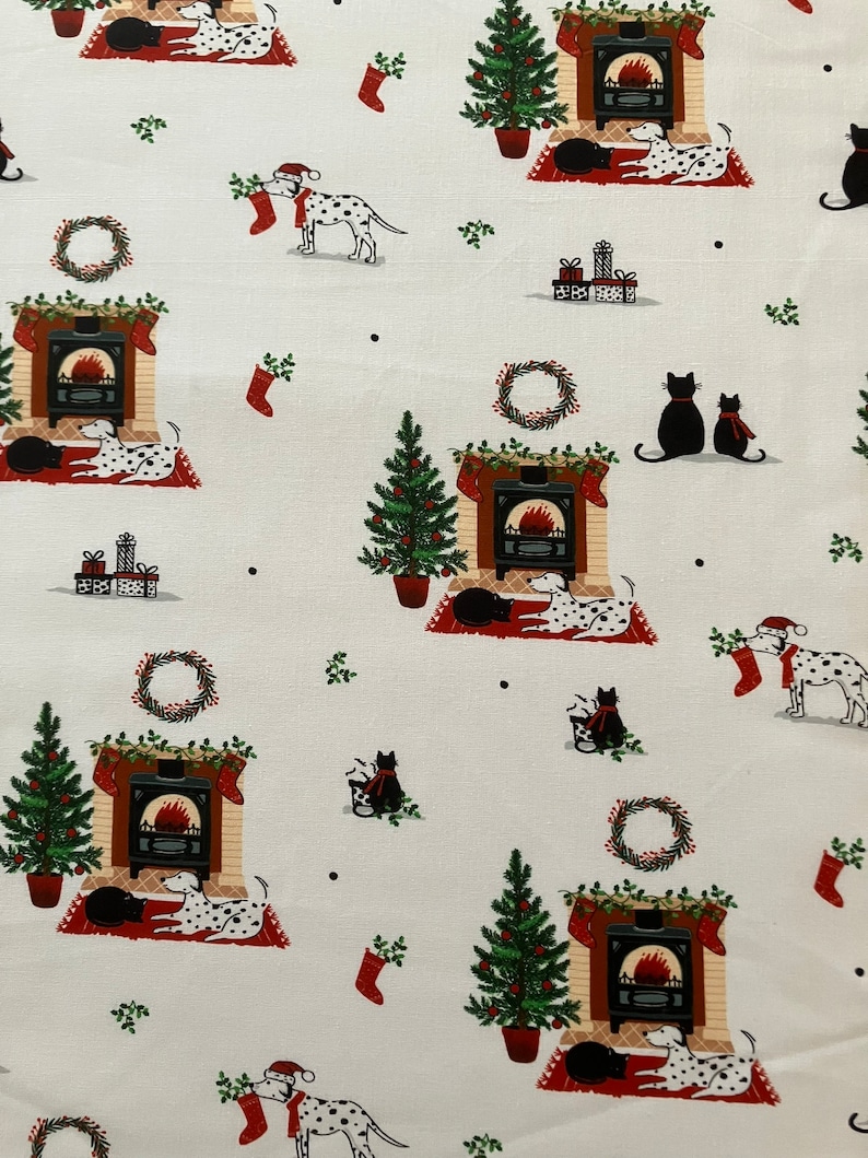 Dalmatian Dog Christmas fabric , features dogs and cats lying by a Christmas fireplace