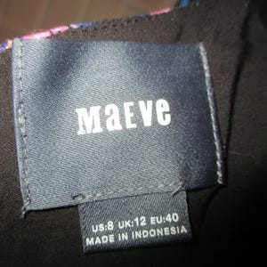 May include: A black and blue patterned dress with a dark blue label that says "Maeve" and "US:8 UK:12 EU:40 MADE IN INDONESIA".