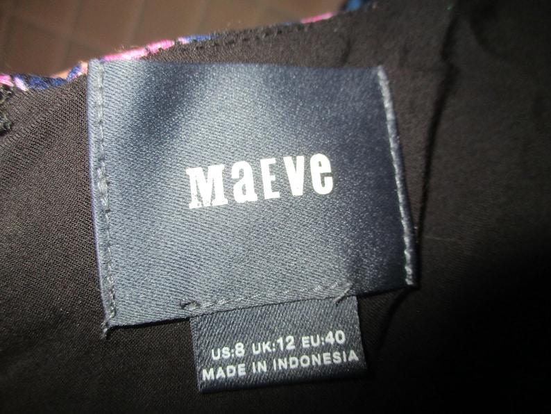 May include: A black and blue patterned dress with a dark blue label that says "Maeve" and "US:8 UK:12 EU:40 MADE IN INDONESIA".
