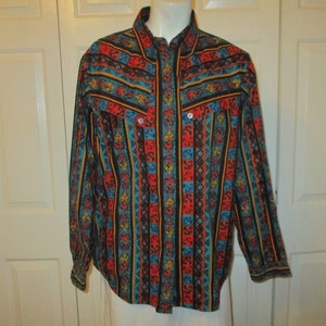 May include: A long-sleeved button-down shirt with a colorful geometric pattern in shades of red, blue, yellow, and black.
