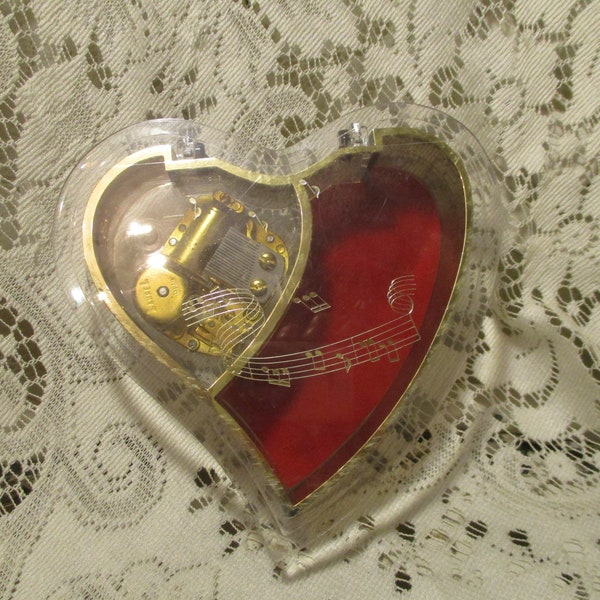 Laurel clear acrylic heart shape music box plays The Music of the night