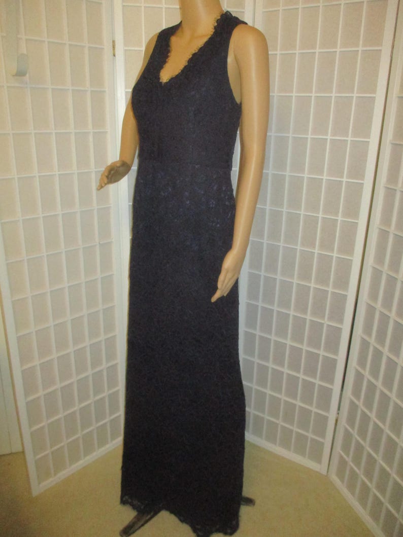 May include: A long, sleeveless, navy blue lace dress with a V-neckline.
