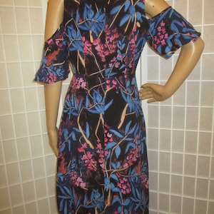 May include: A black floral print dress with cold shoulder straps and short ruffle sleeves. The dress has a fitted bodice and a flowy skirt.