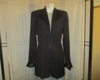 May include: A black blazer with a satin collar and cuffs. The blazer has a fitted silhouette and a single-breasted closure with three buttons.