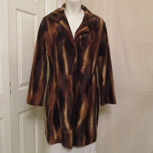 May include: A long-sleeved brown and tan patterned coat with a button closure.