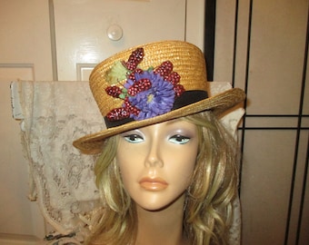 Straw boater hat with berries and purple flower