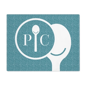 May include: A teal blue cutting board with a white spoon and circle design. The circle contains the letters "P" and "C" and a spoon.
