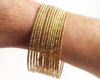Fancy gold bracelets sold in a set of 2 or 10, a chic gift for her to wear alone or with the African wax bracelets