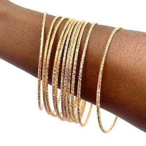 Fancy gold bracelets sold in a set of 2 or 10, a chic gift for her to wear alone or with the African wax bracelets