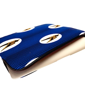 May include: Blue laptop sleeve with a zipper closure and a pattern of white circles with brown birds on a blue and black striped background.