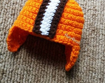 May include: Orange crocheted hat with brown and white stripes. The hat has ear flaps.