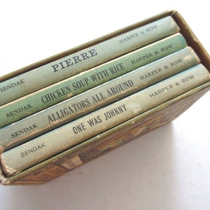 May include: A set of five children's books by Maurice Sendak, including "Pierre", "Chicken Soup with Rice", "Alligators All Around", and "One Was Johnny". Each book is bound in green and features the author's name and the publisher, Harper & Row.