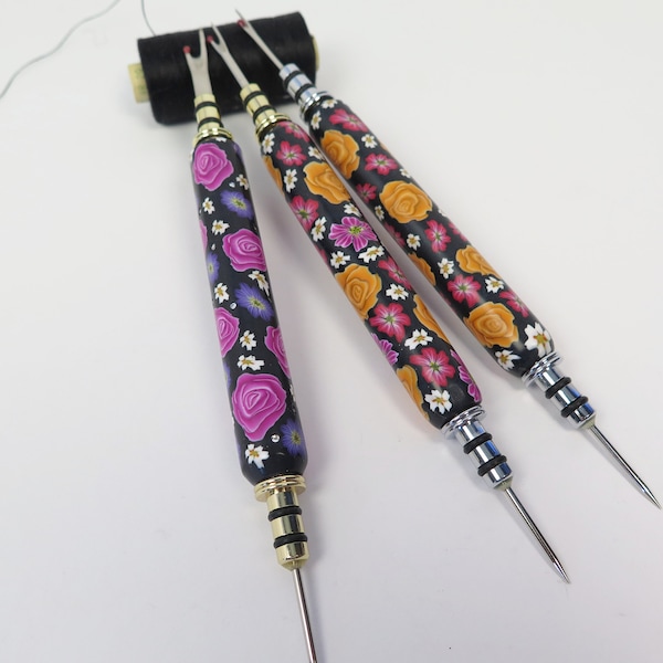 Seam ripper with awl in artistically crafted handle.