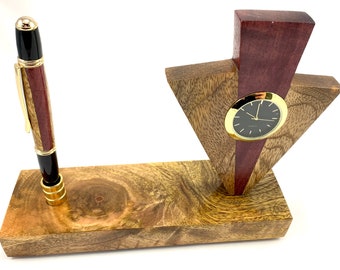 May include: A wooden desk organizer with a clock and a pen holder. The clock has a black face and gold hands. The pen holder is made of wood with a red and black pattern. The organizer is made of wood with a brown and gold finish.