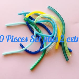 May include: A set of 10 colorful, coiled, plastic cord organizers with 2 extra organizers. The organizers are in shades of blue, green, and yellow.