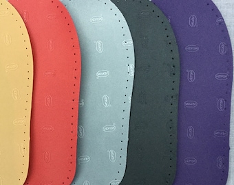 May include: Five different colored shoe soles with a patterned design. The soles are made of a textured material and have a Vibram logo printed on them.