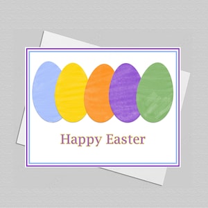 May include: A rectangular greeting card featuring five painted Easter eggs in light blue, yellow, orange, purple, and green arranged in a row. Below the eggs, the text Happy Easter is printed in a simple font. The card has a thin purple and blue border.