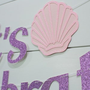May include: Purple glitter banner with the text "Let's Celebrate" and a pink glitter seashell.