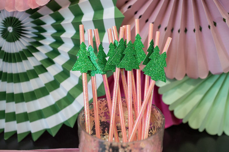 May include: Pink and green striped paper fans with pink and green glitter straws with green glitter Christmas tree toppers.