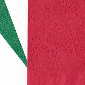 May include: Three paper napkins with embossed snowflake designs. The napkins are green, white, and red.