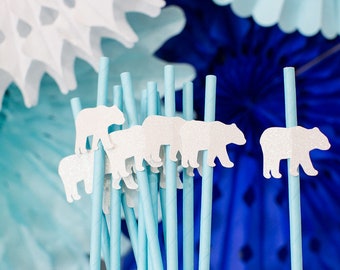 May include: Blue and white paper straws with white polar bear cutouts attached to the top. The straws are arranged in a group.