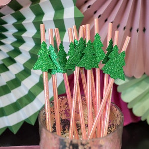 May include: Pink and green striped paper fans with pink and green glitter straws with green glitter Christmas tree toppers.
