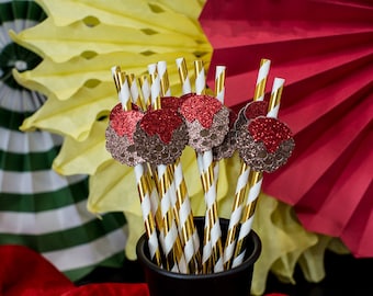 May include: A bunch of gold and white striped paper straws with red and brown glitter skull toppers.