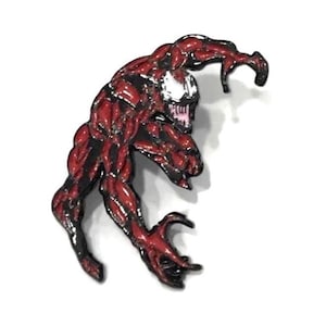 May include: A red and black enamel pin depicting the Marvel Comics character Carnage. The pin features the character in a dynamic pose, with detailed musculature and sharp claws. The character's face is white with black accents.