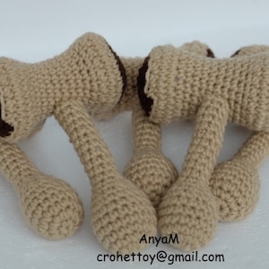 May include: Five crocheted brown and beige toy hammers. The hammers are arranged in a circle with the handles pointing outwards.