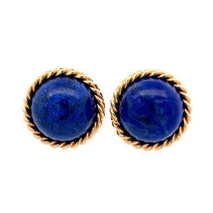 May include: A pair of gold earrings featuring blue lapis lazuli stones. The stones are set in a rope-like gold design.