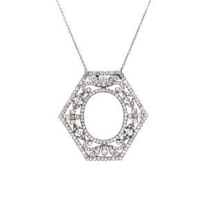 May include: A silver necklace with a hexagonal pendant set with small diamonds. The pendant features a circular opening in the center.