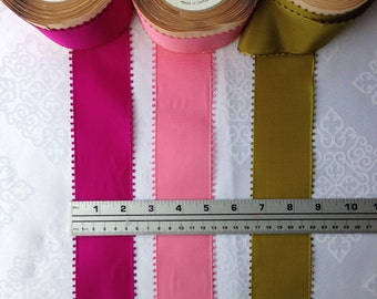 May include: Three spools of ribbon with a picot edge. The spools are labeled "Picot - St. Moritz" and "Pattern Royalty" with the color number and yardage. The ribbon colors are fuchsia, pink, and olive green.