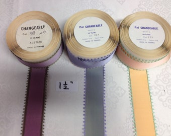 May include: Three spools of ribbon with different colors and patterns. The spools are labeled "CHANGEABLE" and have the text "10 Yards" and "Col 98", "Col 221", and "Col 225" on them. The ribbon is 1 inch wide.