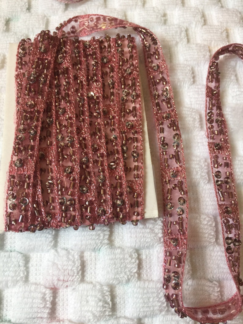 Pode incluir: Bordado de contas rosa com uma base de tecido transparente. O bordado &eacute; feito de pequenas contas redondas e tem um visual delicado e feminino.