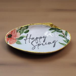 May include: A set of three ceramic mugs with a speckled, matte finish. The mugs are in shades of cream, light gray, and dark gray. Each mug has a simple, minimalist design, perfect for coffee or tea.