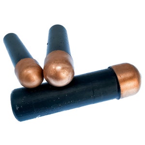 May include: Three black and copper welding rods. The rods are about 6 inches long and have a copper tip.