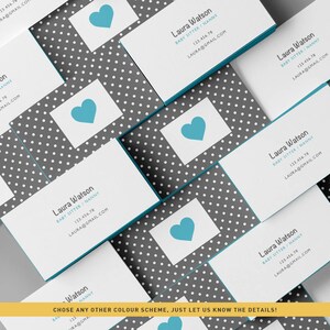 May include: Stack of business cards with a gray and white polka dot pattern. The cards have a blue heart icon and the text "Laura Watson Baby Sitter/Nanny 123.456.78 LAURA@GMAIL.COM" printed on them.