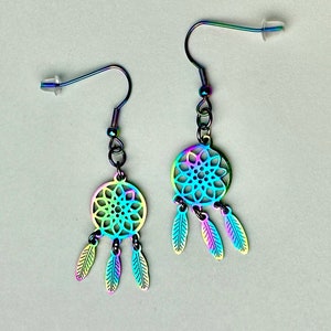 May include: A pair of iridescent rainbow dreamcatcher earrings with feather accents.