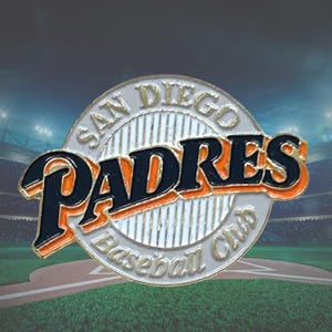 May include: A circular metal pin featuring the San Diego Padres Baseball Club logo. The design includes the word Padres in large dark blue letters with orange outlines, set against a white background with vertical lines and text around the edge.