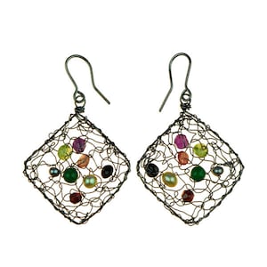 May include: A pair of silver wire earrings with a square shape. The earrings are decorated with a variety of colourful gemstones and pearls.