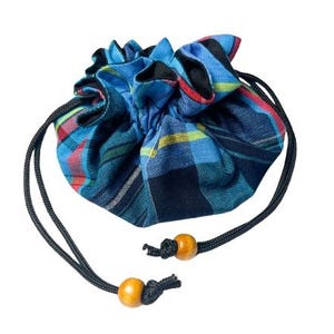 May include: A blue and black plaid drawstring bag with a black cord and wooden beads.