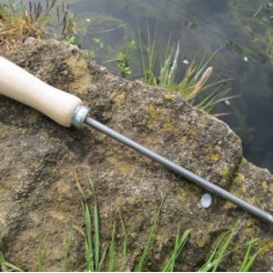 May include: A wooden-handled metal tool with a pointed tip, likely used for pond or lake maintenance.