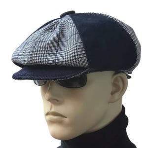 May include: A newsboy cap featuring a black and white houndstooth pattern on the front panels and solid black fabric on the side panels and brim. The cap has a button detail on the top center and is worn with dark-tinted sunglasses.
