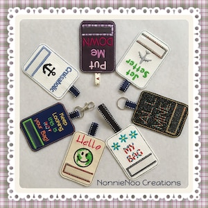 May include: A set of 10 colorful luggage tags with various embroidered designs and text. The tags include phrases like "Put Me Down", "Jet Setter", "All Mine", "Keep Looking This Is Not Your Bag", "Hello", and "My Bag".