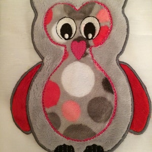 May include: A gray owl applique with pink and red polka dots and a pink heart. The owl has large black eyes and red wings.