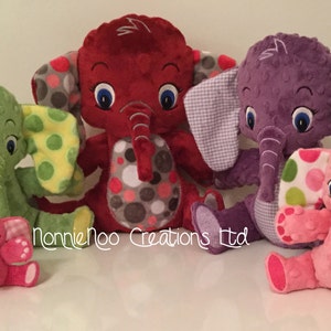 May include: Four plush elephant toys in different colors and patterns. The elephants are sitting on a white surface. The text "NannieNoo Creations Ltd" is visible in the bottom center of the image.