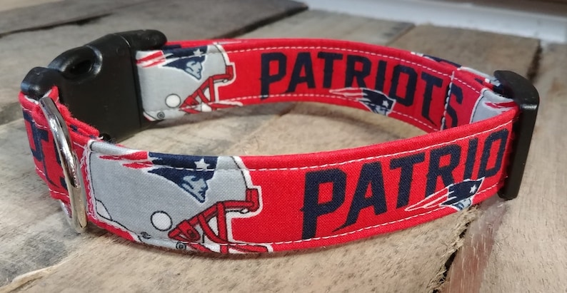 May include: Red, white, and blue dog collar with a Patriots logo and the word "Patriots" printed on it.