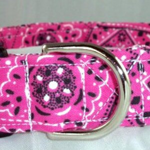 May include: Pink and black bandana print dog collar with a silver buckle.